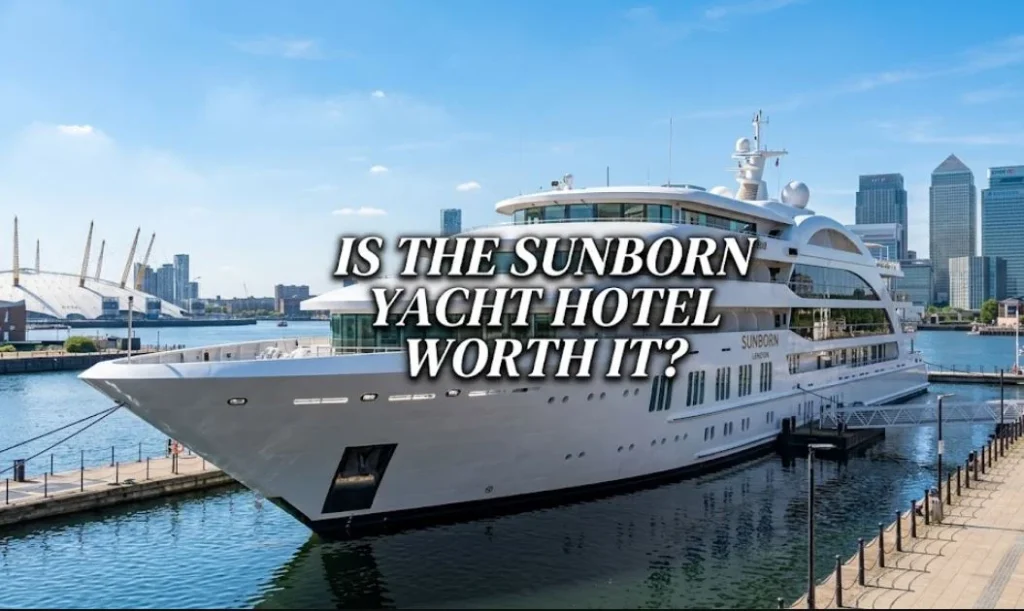 Sun born london image,The Sunborn London super yacht hotel docked in the Thames with the London skyline in the background, with text overlay reading 'IS THE SUNBORN YACHT HOTEL WORTH IT?'.